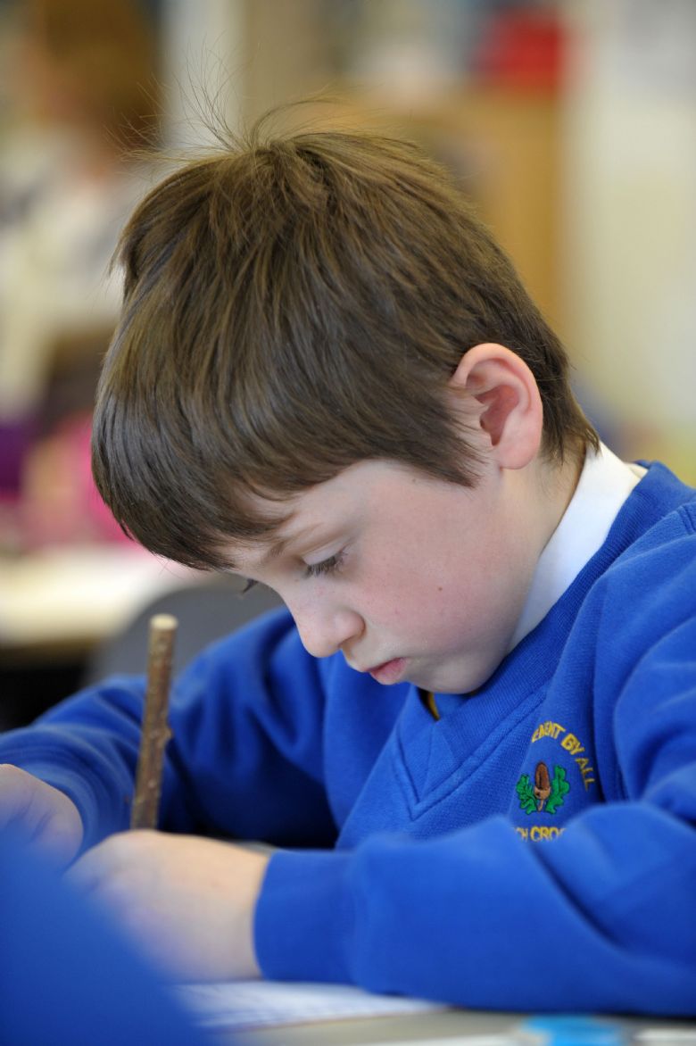  A pupil working hard at their writing