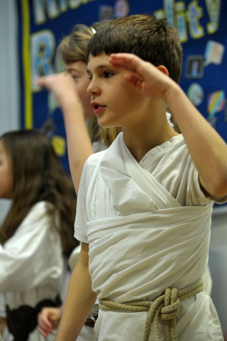  A child dressed as an Ancient Greek with other children in background