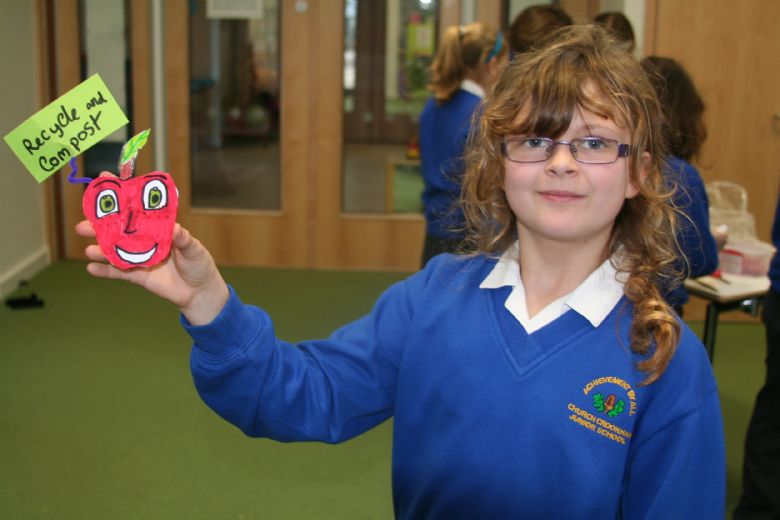  A child with her fridge magnet to promote recycling and composting
